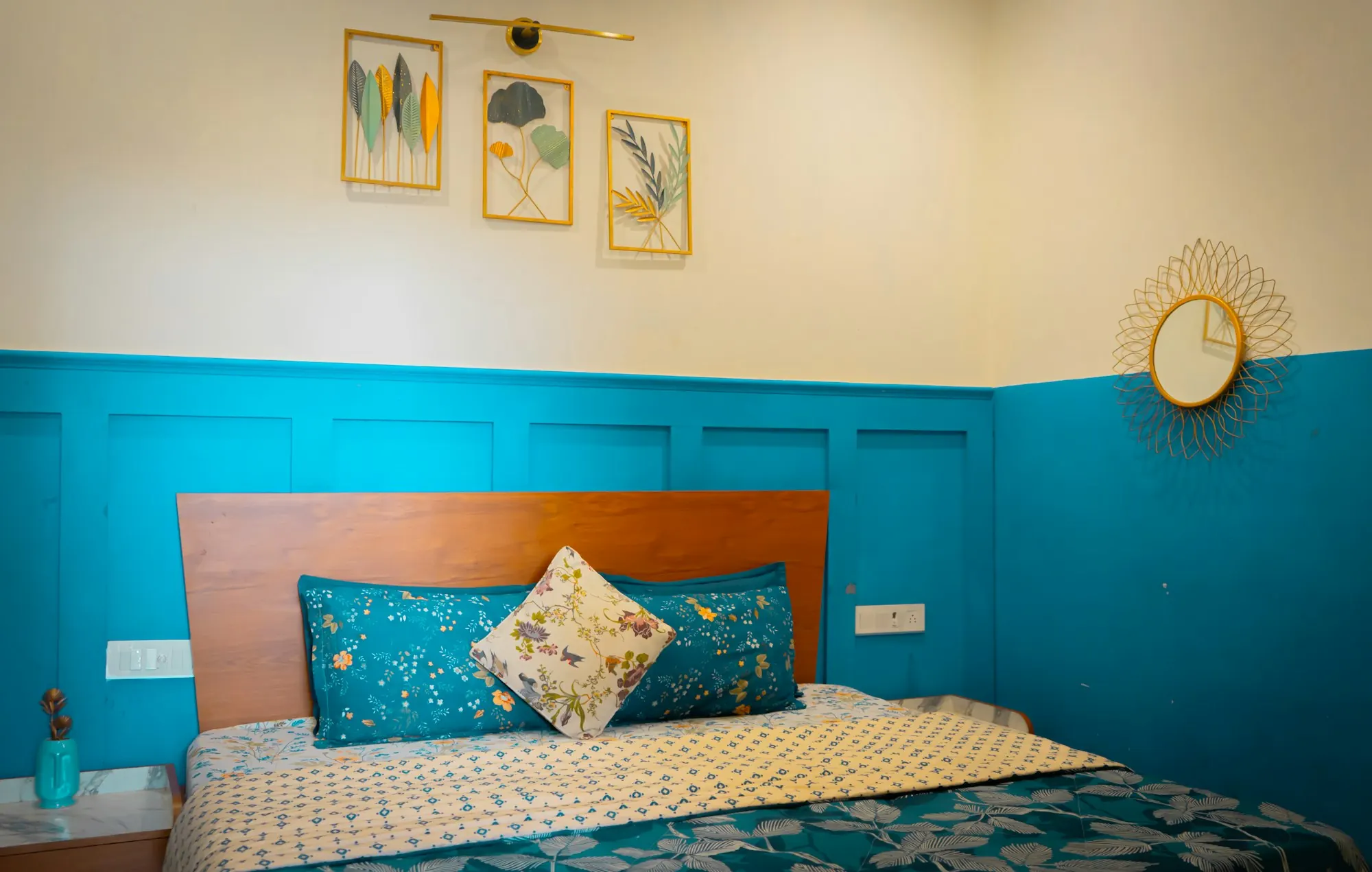 A bed made with a bright printed bedsheet and pillow covers