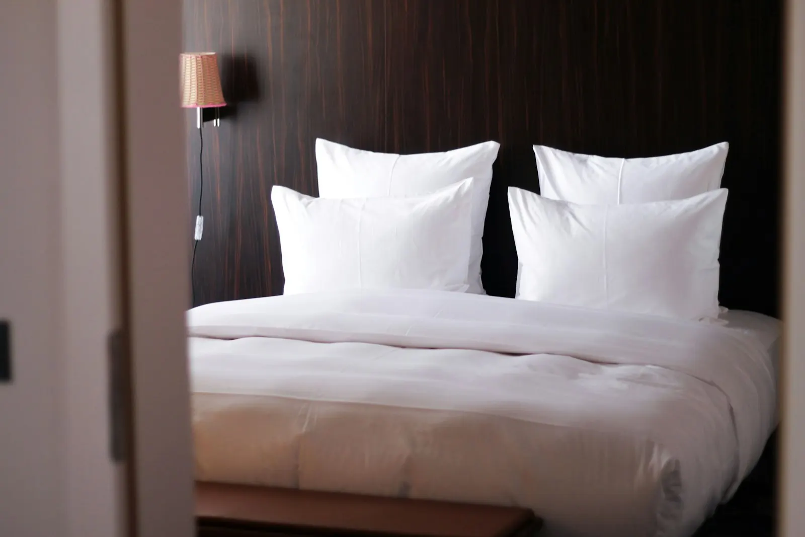 Crisp white bed linen on a hotel bed